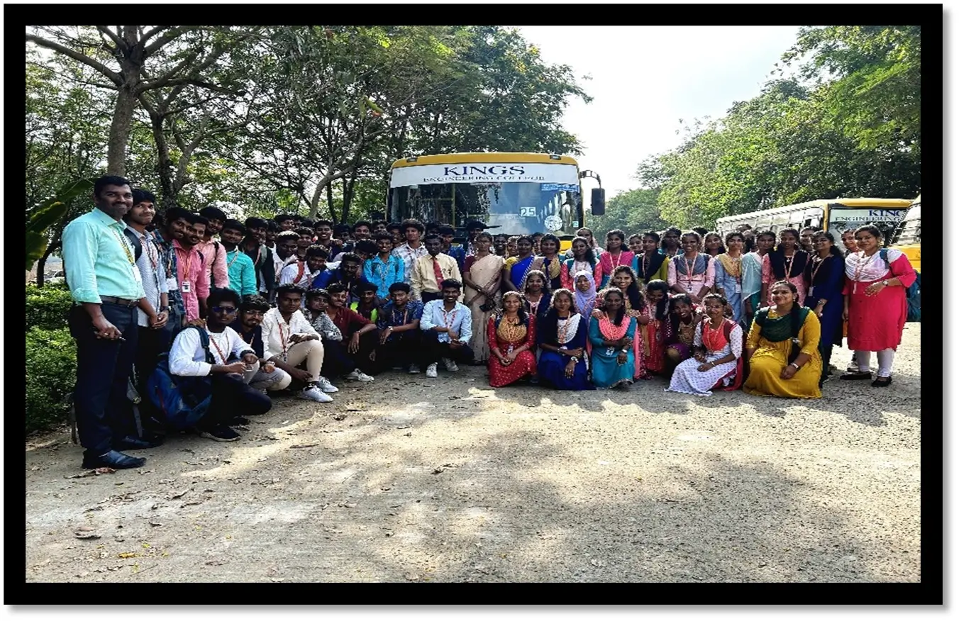 group of students posing in front of college bus
